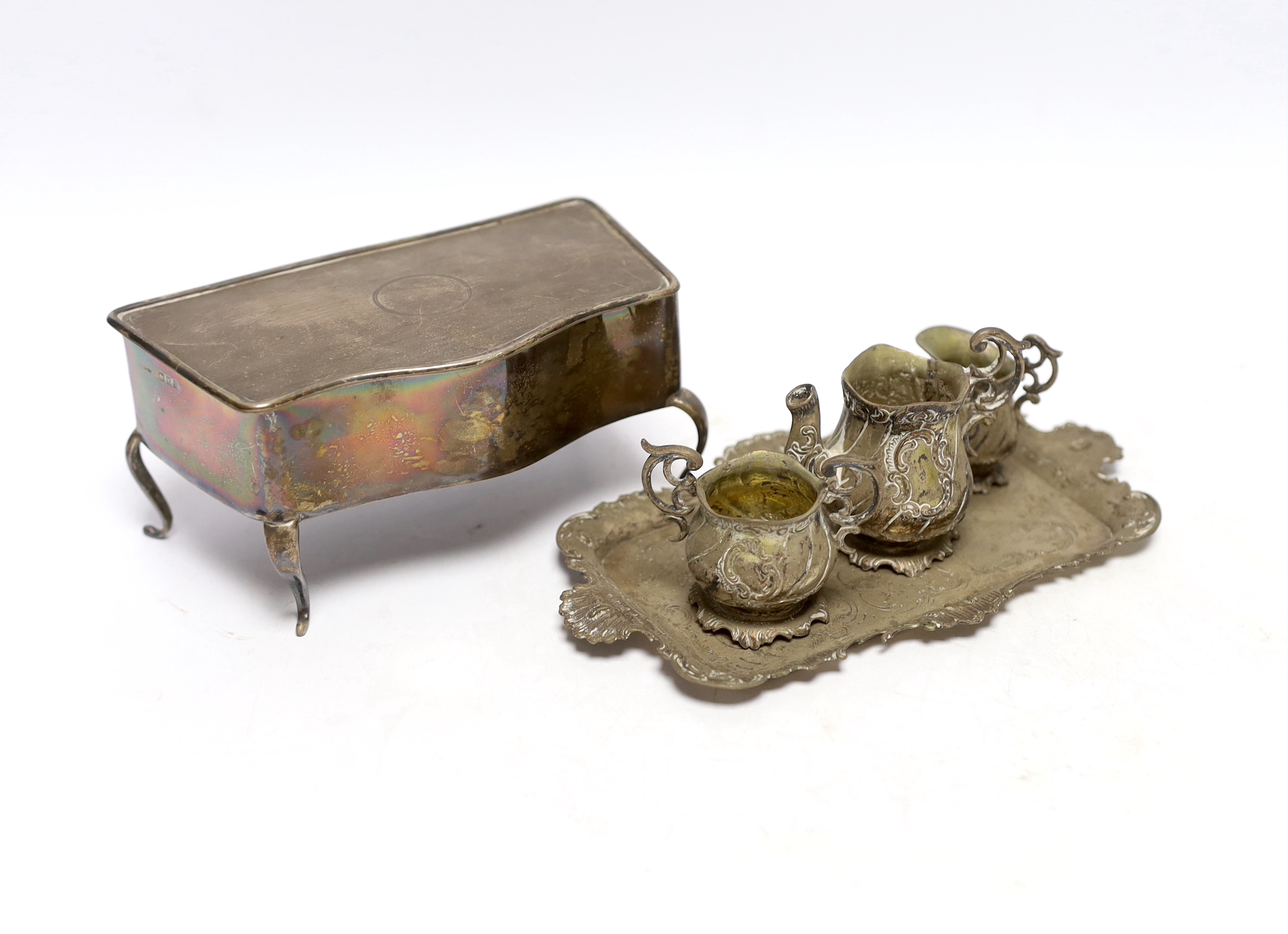 A German Hanau white metal miniature tea set and tray, tray 18.2cm, together with a George V silver mounted trinket box, London, 1922.